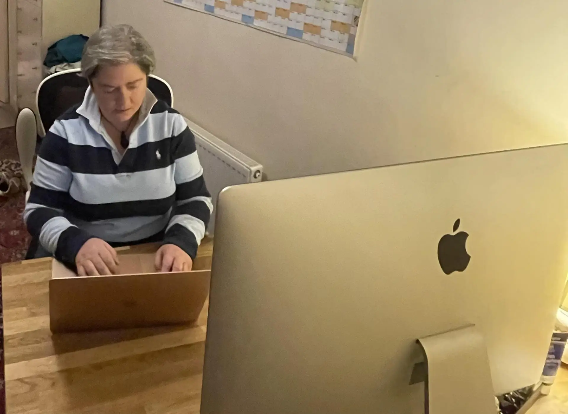 Working at a desk with a computer, taking a safeguarding enquiry